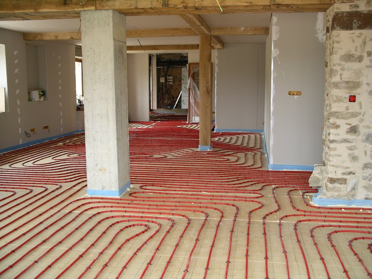 Geothermal-fed underfloor heating pipework across the barn floor