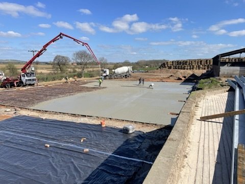 Concrete base being poured by concrete pump