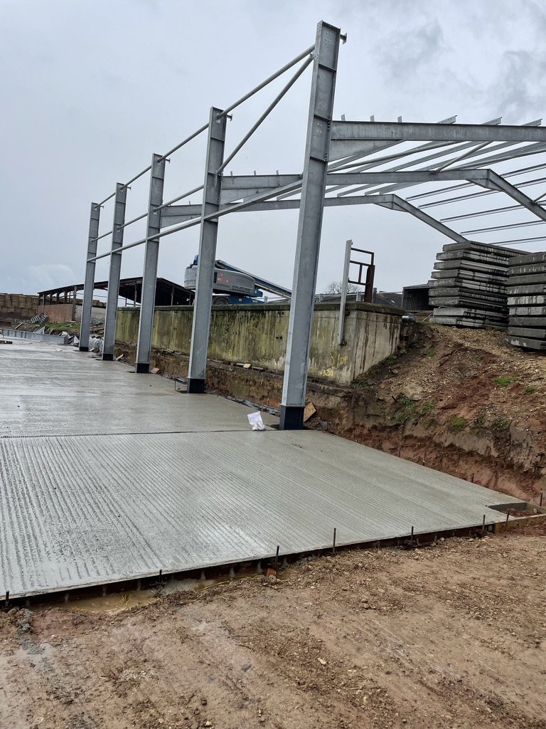 Steel portal frame erected over the concrete walls