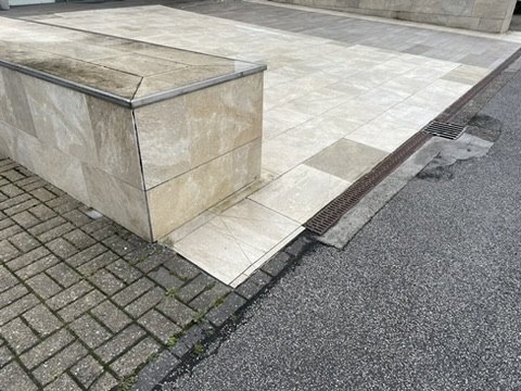 Hidden linear drainage channel set into the paving